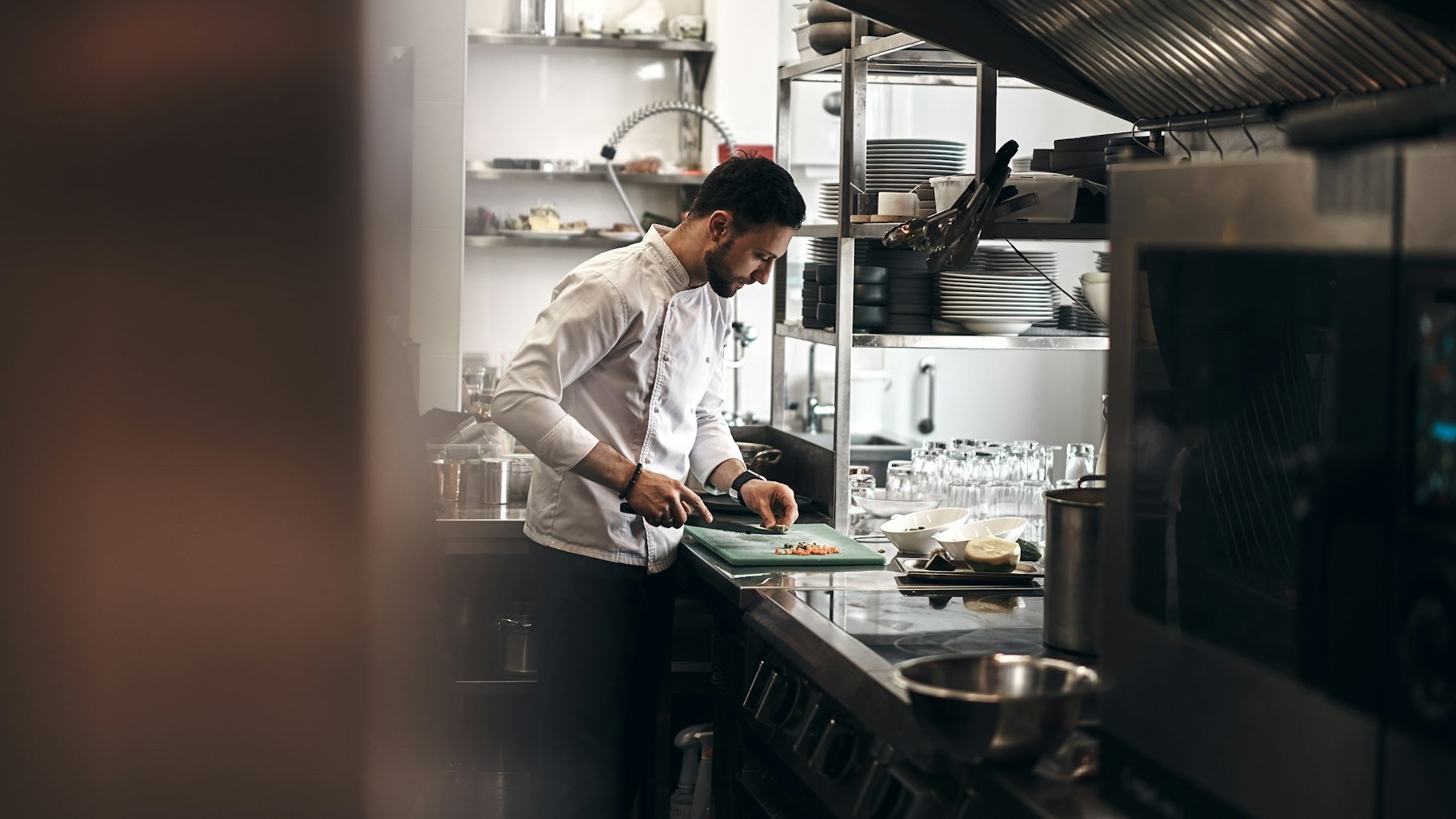 A chef preparing food in a professional kitchen